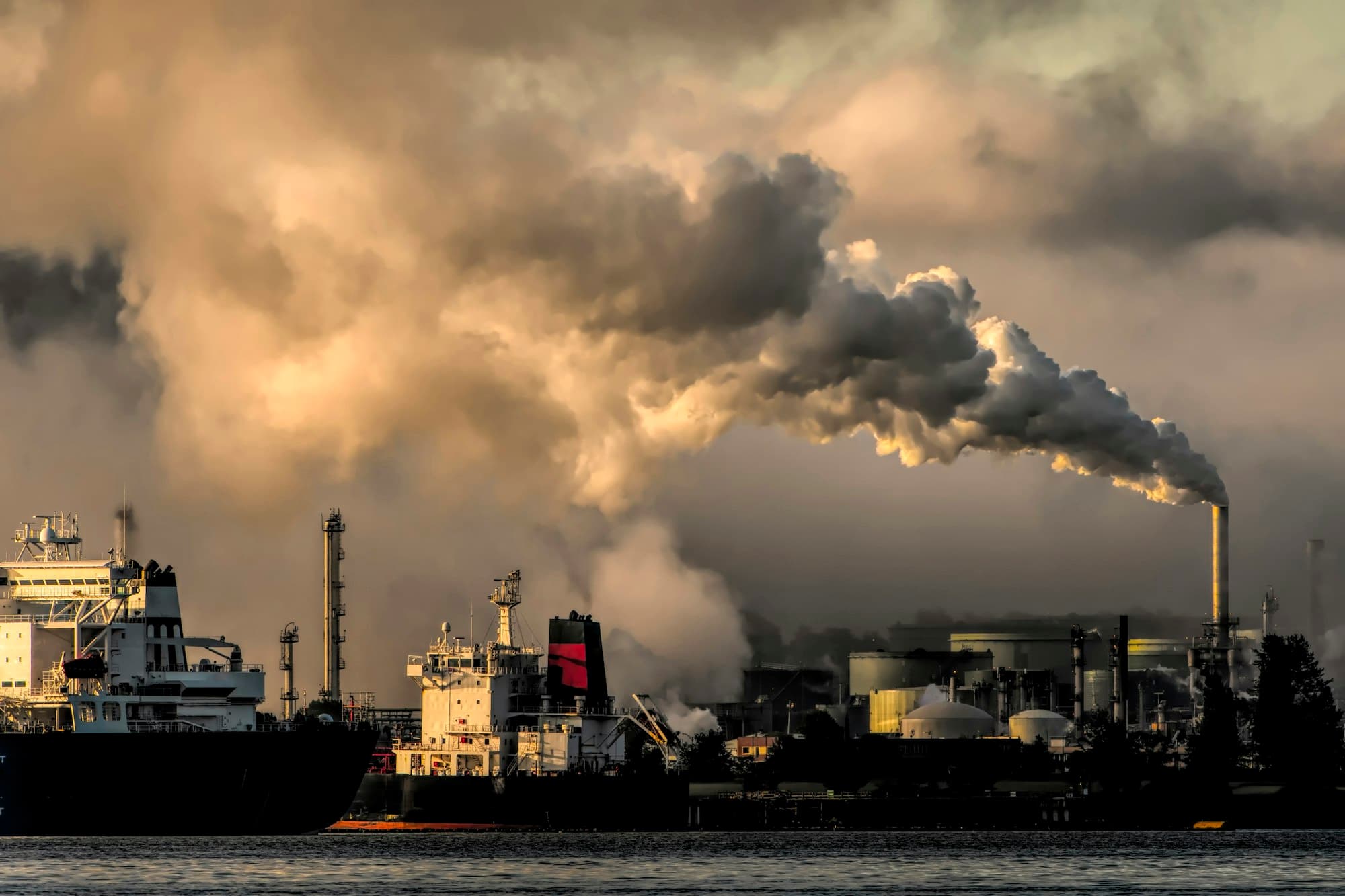Industrial emissions against a hazy sky